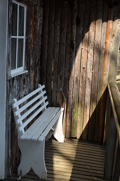 istock Wooden bench on a sunny porch 470970800