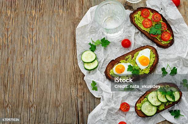 Rye Sandwiches And Mashed Avocado Eggs Tomatoes And Cucumbers Stock Photo - Download Image Now