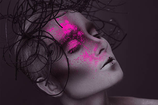 istock Gorgeous woman with pink neon powder on face 470971741