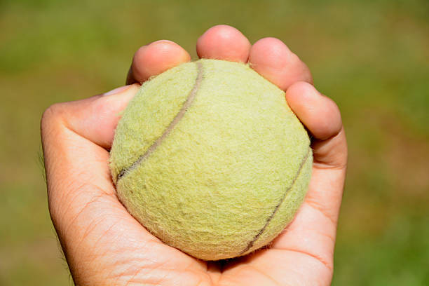 istock tennis ball in human hands 470971968