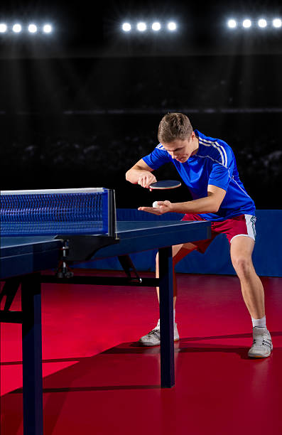 istock Young man playing table tennis in a stadium 470972482