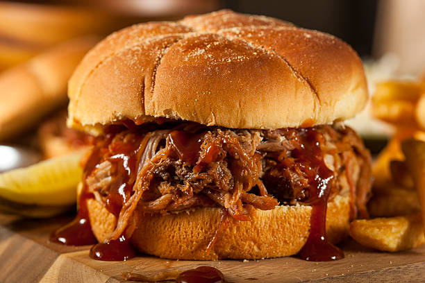 Barbeque Pulled Pork Sandwich Barbeque Pulled Pork Sandwich with BBQ Sauce and Fries sloppy joes stock pictures, royalty-free photos & images