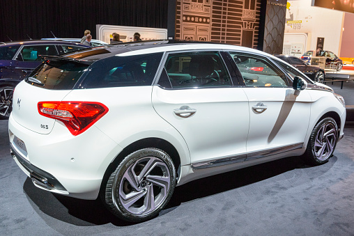 Amsterdam, The Netherlands - April 16, 2015: Citroen DS5 luxury crossover hatchback car on display during the 2015 Amsterdam motor show. People in the background are looking at the cars.