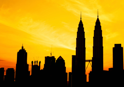silouette of KLCC and other skyscraper tower during golden sunrise