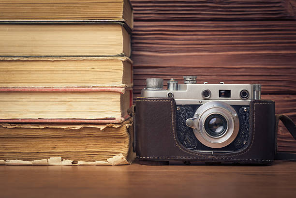 istock Vintage Camera and Stack of Books Over Wooden  Background 470976848
