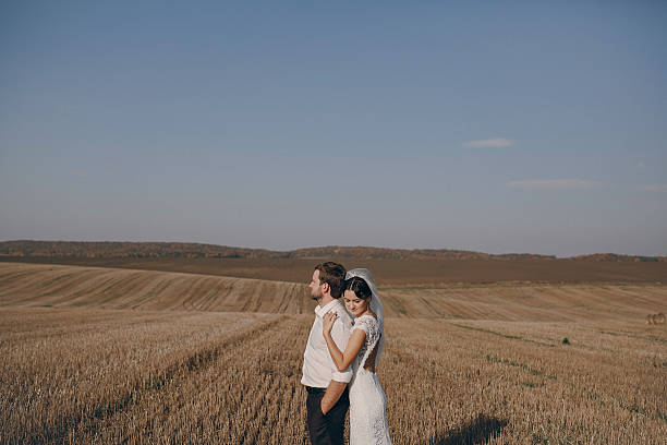 istock happy wedding couple in a field 470982858