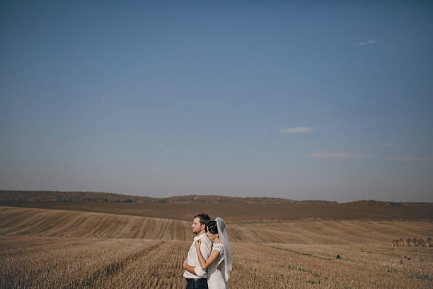 istock happy wedding couple in a field 470982866