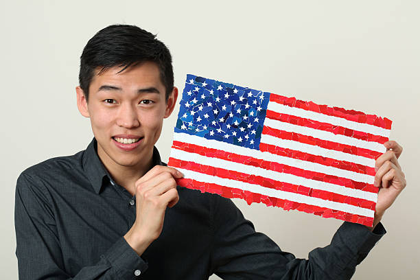 istock Young Asian student showing US national flag 470983412