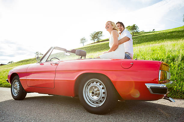 istock Happy young couple in a cabriolet 470983587