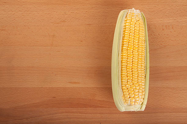 istock Sweetcorn on wooden table 470984018