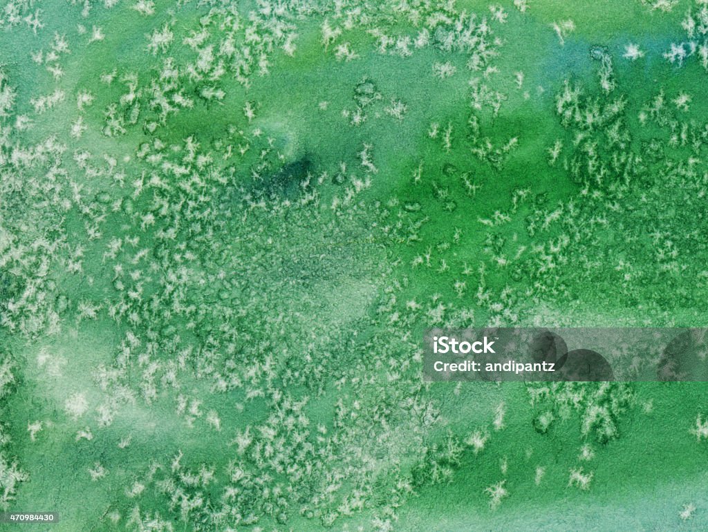 Green textured watercolor background on paper Hand painted abstract watercolor. There are shades of green as the prominent color in this painting. there is a texture of paint movement and pooling, as well as a flakey texture that resembles snowflakes. 2015 Stock Photo