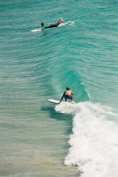 Surfers at the Pass, Byron Bay Surfing at the Pass, Byron Bay byron bay stock pictures, royalty-free photos & images