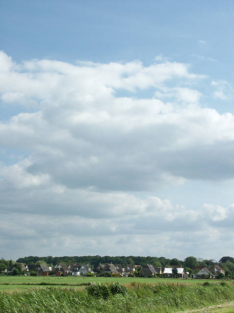 istock Village under Dutch sky wih meadow 470987755