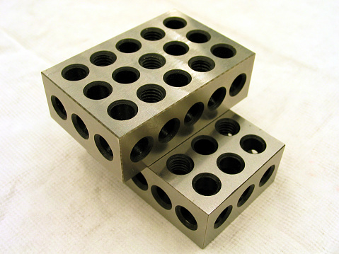 A shot of two precision machined blocks used for measuring stacked on top of each other.  They get their name from their dimensions: 1
