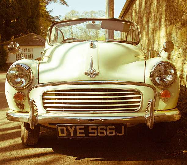 Beaconsfield, Buckinghamshire - May 15, 2021: Close up of a rain-spattered headlight of a dark blue Volvo 1800S from 1967, parked up in the historic town of Beaconsfield in Buckinghamshire, UK.