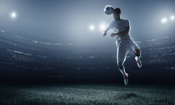 istock Soccer player kicking ball in stadium 470990700