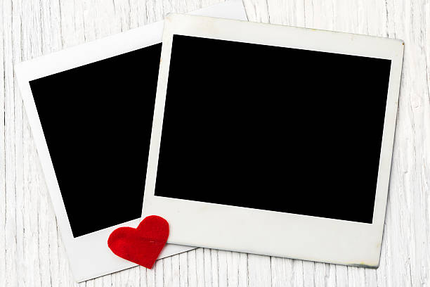 istock Blank instant photo frames anh heart on old wooden background 470991368