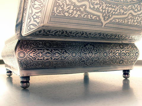 A silver box with arabian and Indian pattern on it.