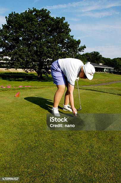 Inserting A Tee Stock Photo - Download Image Now - 80-89 Years, Active Seniors, Activity