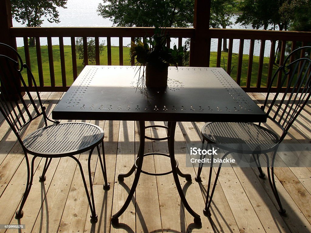 Table & Chairs on Patio - Real Estate Table hairs on upper deck as it overlooks lake Abbey - Monastery Stock Photo