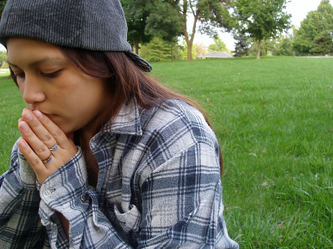 Teenage girl thinking/praying