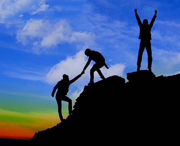 istock Silhouette of helping hand between two climber 470996128