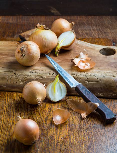 istock Onions slicing on wooden cutting board 470996594