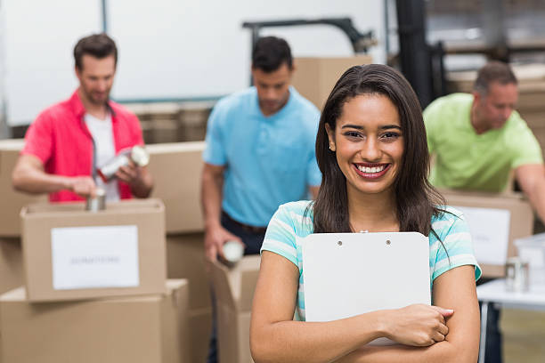 istock Smiling young female volunteer holding clipboard 470997292