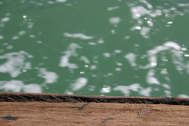 Off the side of an old wooden boat stock photo