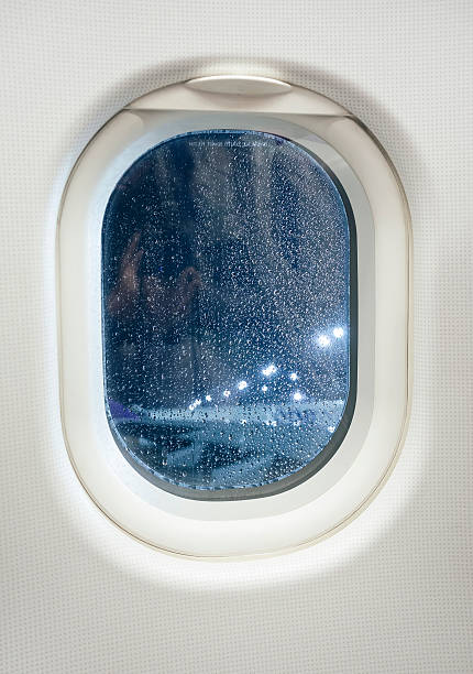 istock Airplane window view at Night with rainy condition 470998818