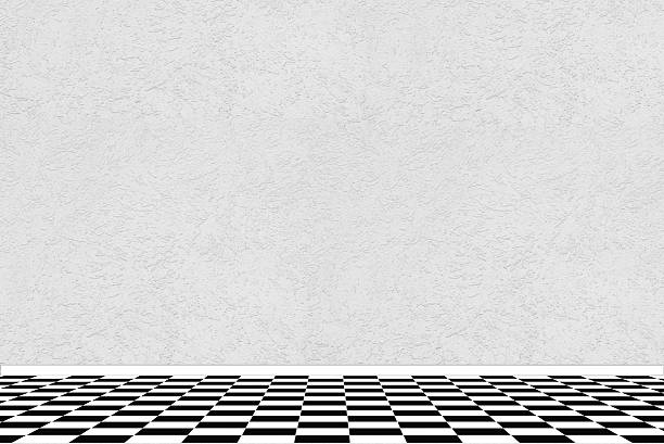 istock Textured white wall with black and white checkered floor tiles 471001428