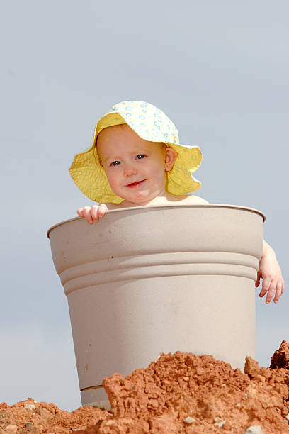 Child in Bucket II The mother wanted this shot to create a birthday card for her daugther left handed catcher stock pictures, royalty-free photos & images
