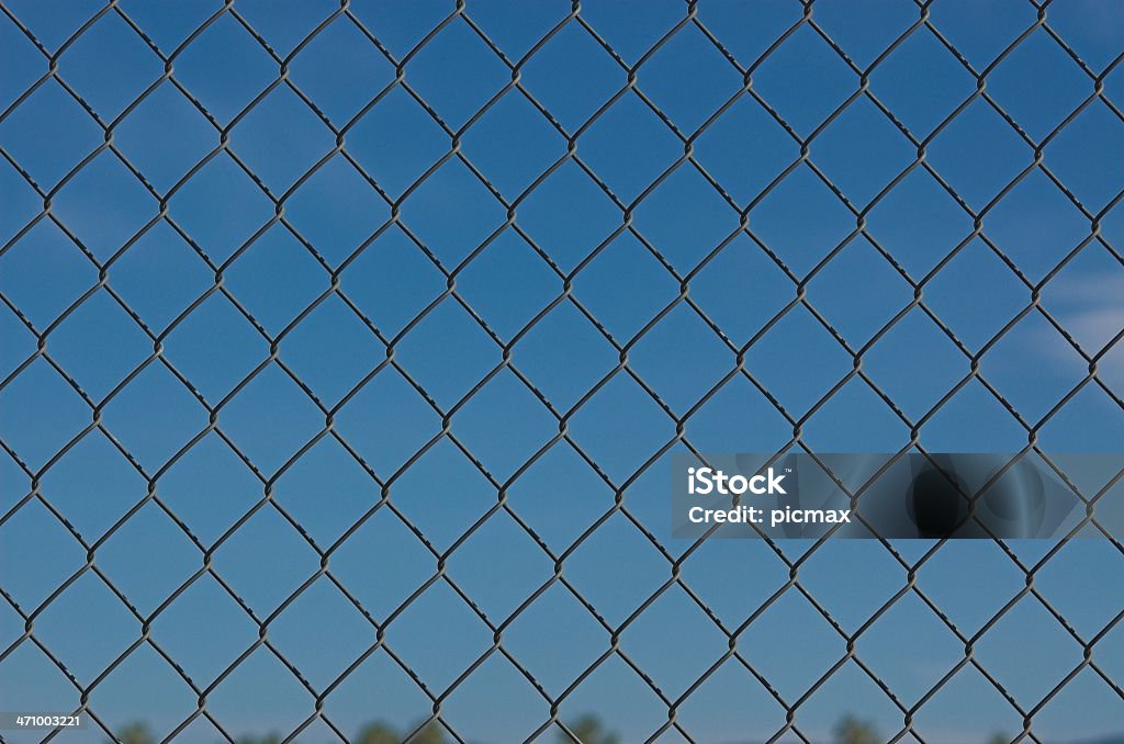 Chain link fence blue sky Chain link fence against blue sky Agricultural Field Stock Photo