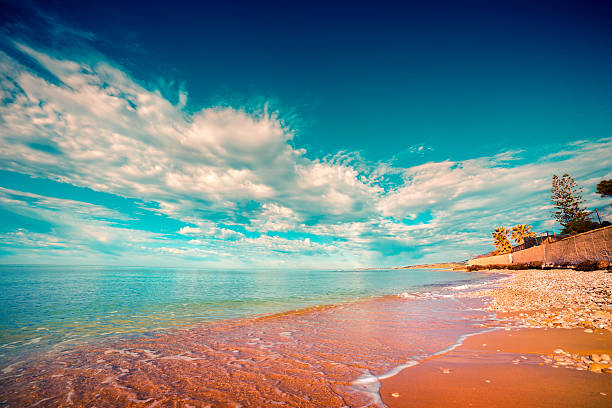 a seashore weather clouds coastal ocean shore blue harbor cove water sea sunshine