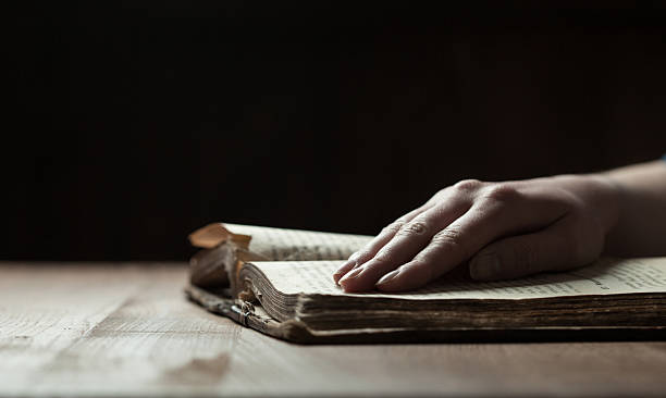 istock woman hands on bible 471006126