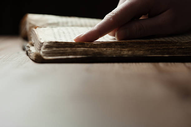 istock woman hands on bible 471006132