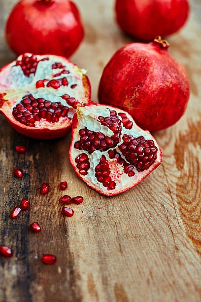 istock pomegranates on a dark wooden background 471008662