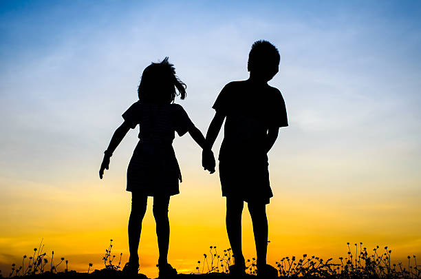 istock Little brother and sister silhouette 471009814