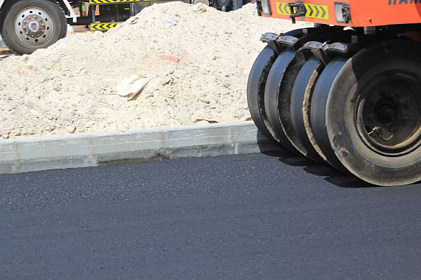 istock Roller flattening newly laid tarmac on a road 471009878