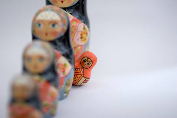 orange russische puppe, standing out - russian nesting doll russia doll matrioska stock-fotos und bilder