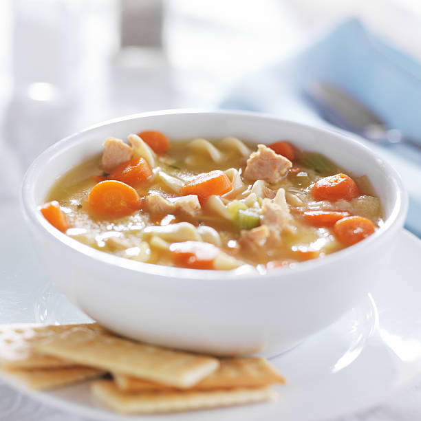 istock hot bowl of chicken noodle soup on table 471014668