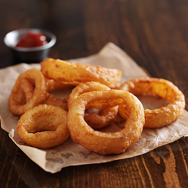 istock crispy onion rings with ketchup on parchment paper 471014680