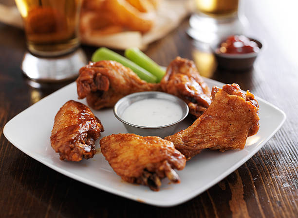 istock Hot buffalo barbecue chicken wings on a white plate 471014688