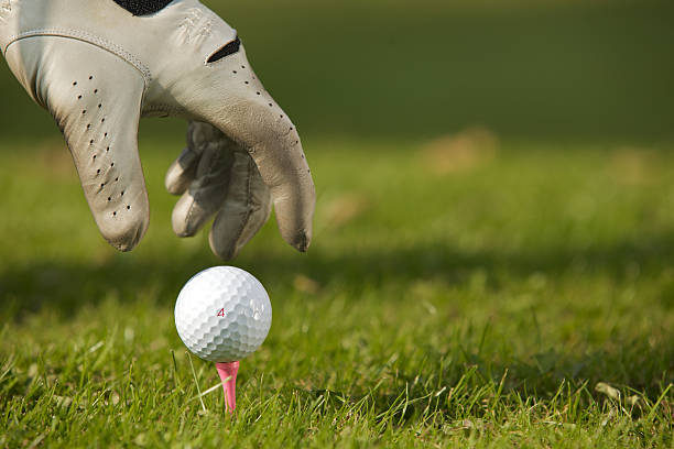 istock Human hand positioning golf ball on tee, close-up 471015038