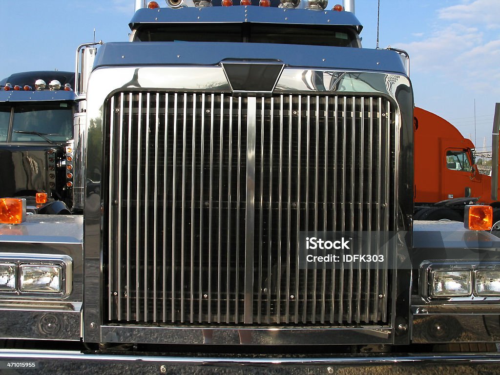 Big Truck New conventional cab semi-truck on dealer's lot. Shot straight on to emphasize the massive, chrome grille. Then I jumped out of the way at the last second. Truck Stock Photo