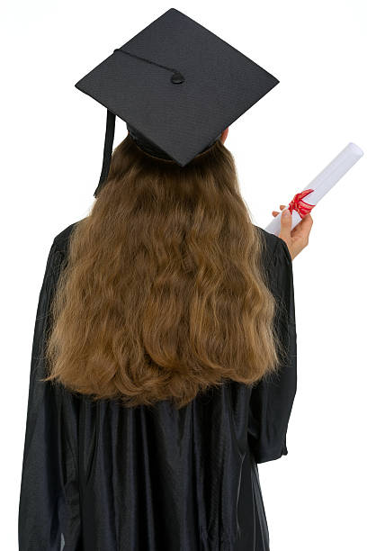 istock graduation female student with diploma standing back 471018418