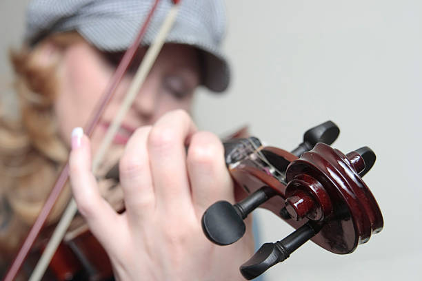 istock woman playing the violin 471020883