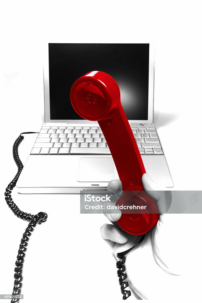 Help Desk Color isolated red phone receiver against a grayscale notebook computer. Conceptual Balance Stock Photo