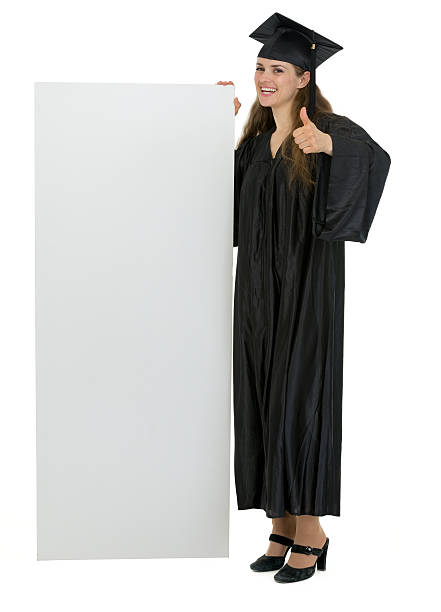 istock graduation student holding blank billboard and showing thumbs up 471024944