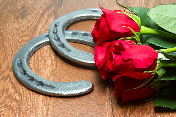 Kentucky Derby Red Roses with Horseshoes on Wood stock photo